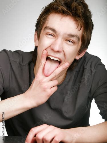 Smiling Fun Man With Victory Gesture And Put Ones Tongue Out Stock