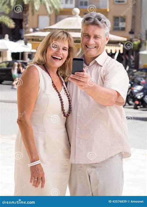Married Mature Couple Of Travelers Posing For A Selfie Photo In Tropical City Stock Image