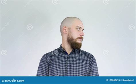 The Bald Guy With The Bushy Beard Turns His Head Showing His Hair Style