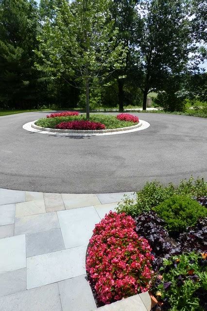 Large Circular Driveway With A Center Island Intersects With Bluestone