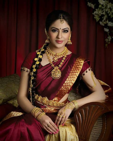 image may contain 1 person sitting south indian wedding saree south indian bridal jewellery