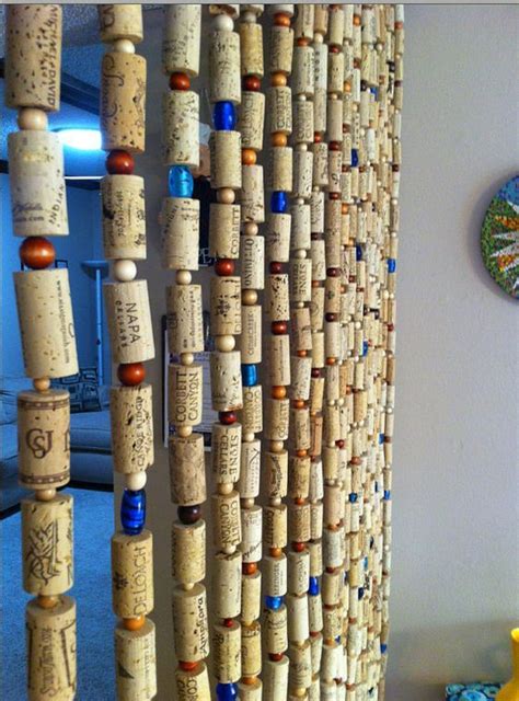 There Are Many Wine Corks Hanging On The Wall Next To Each Other In