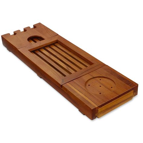Designed with your pampering in mind, this beautiful teak bathtub caddy features ample space for all the trappings of a luxurious bath. The Genuine Teak Bath Tray - Hammacher Schlemmer
