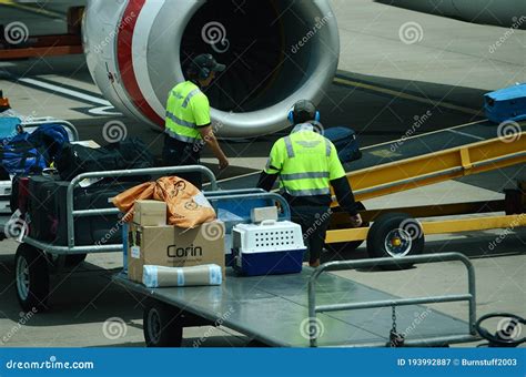 Airport Airside Passenger Aircraft Baggage Handlers Loading Bags In
