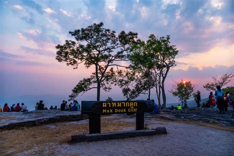 Tourists Sit And Watch The Sunset View At Mak Dook Cliff Phu Kradueng