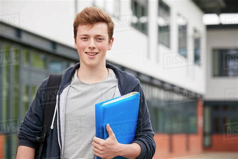 Portrait Of Male Student Standing Outside College Building Stock