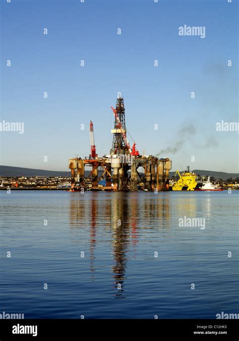 A Semi Submersible Oil Rig Is Maneuvered Alongside The Dock At