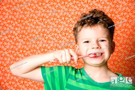 Little Boy Brushing Teeth With A Toothbrush Stock Photo Picture And