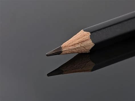 Premium Photo Closeup Of Black Pencil With Reflection On Black