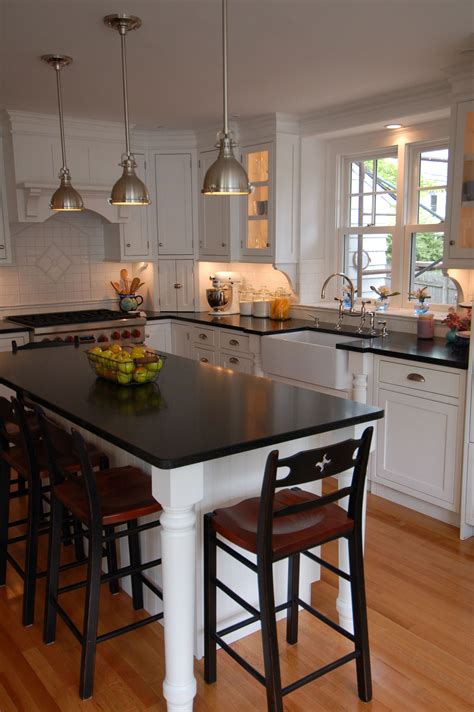Even if your kitchen is on the narrow side, you can still bring in a slim kitchen island for prep space and conversation. Sink and stove location - with Island and lamps - perfect ...