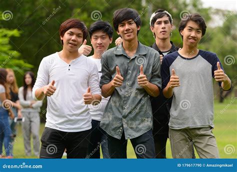 Happy Young Group Of Friends Giving Thumbs Up Together At The Park
