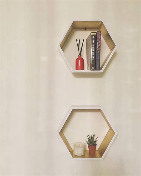 This decorative hexagon honeycomb wall shelf is truly a masterpiece in striking silver metal and white marble shelves. White and gold hexagon shelves. wall design, interior ...