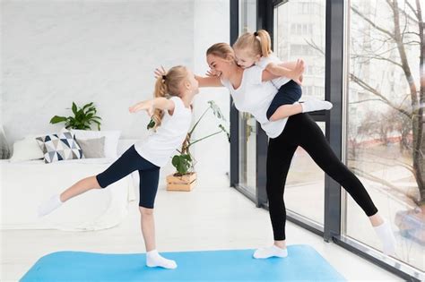 Free Photo Top View Of Happy Mother Posing With Daughter On Yoga Mat