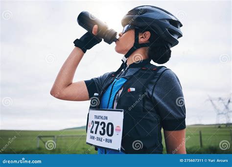 Fitness Cyclist Or Woman Drinking Water In Park To Hydrate Relax Or