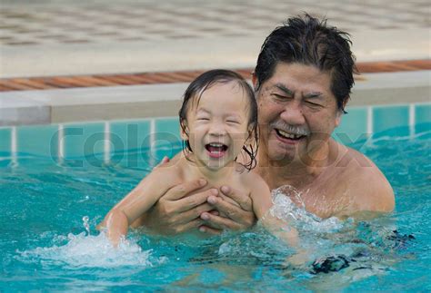 Grandfather With Granddaughter In The Pool Stock Image Colourbox