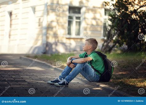 Sad Alone Boy Sitting On Road In The Park Outdoors Stock Photo Image