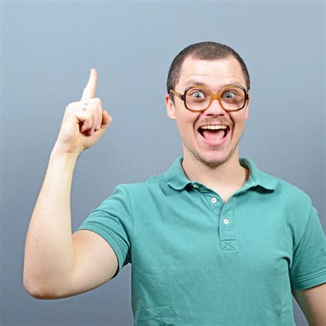 Portrait Of Funny Nerd Guy Having An Idea Against Gray Background Stock Image Image Of Face