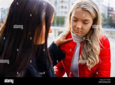 Young Woman Comforting Her Upset And Sad Friend Outdoor Stock Photo Alamy