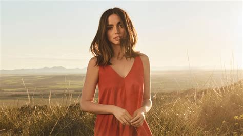 Ana De Armas With Red Dress In Background Of Field Mountain And Blue