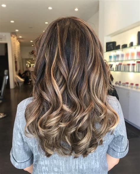 The toffee hue serves as the perfect contrast to the dark base color. 32 Best Pictures Black Long Hair With Blonde Highlights ...