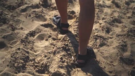 man in sandals walking on sandy beach stock footage videohive