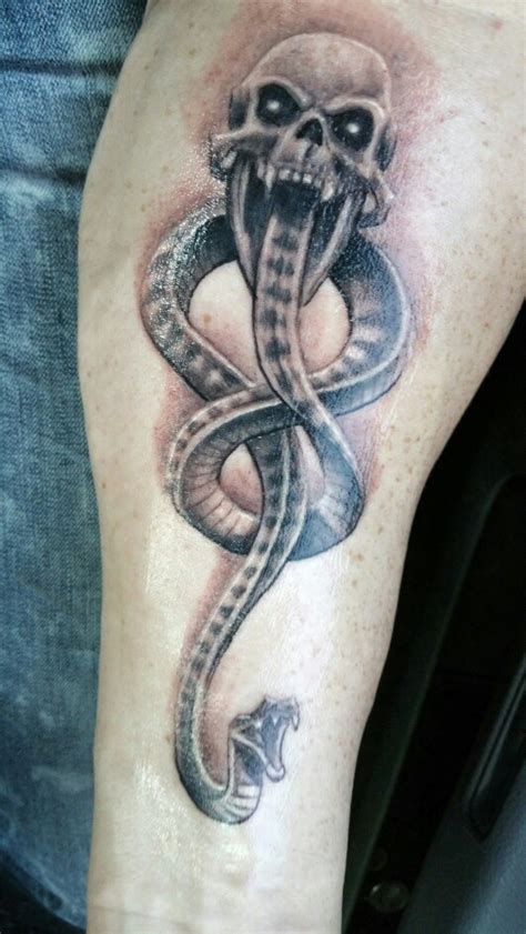 A mandala inspired neck piece ends between the wearer's shoulder blades in this tattoo. Dark Mark Tattoos Designs, Ideas and Meaning | Tattoos For You