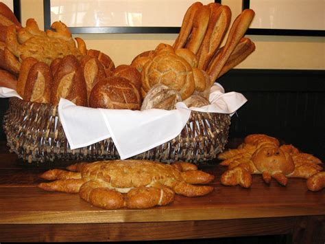 breads and pastries in a basket on a table