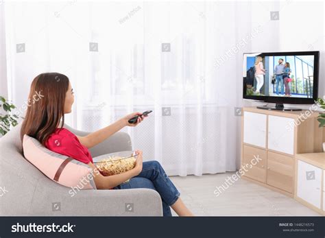 Young Woman Watching Tv On Sofa Foto Stock 1448216573 Shutterstock