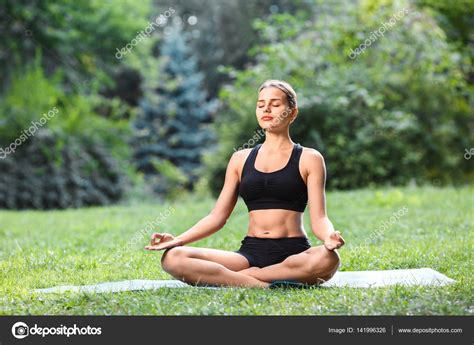 Woman Practicing Yoga Outdoors Stock Photo Image By Velesstudio