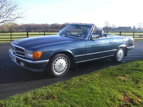 Classic white exterior with blue leather interior. 1982 MERCEDES 380 SL AUTO BLUE/SILVER