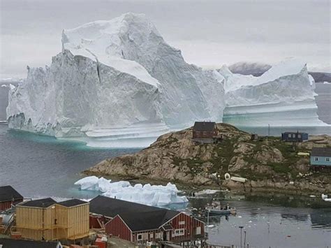 Greenland Village Watches Looming Iceberg Express And Star