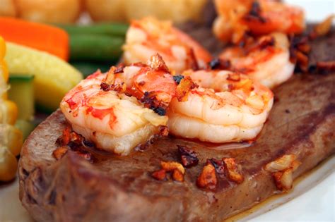 The term 'surf and turf' is use for a traditional meal consisting of both lobster and steak. NY Strip Steak with Shrimp Scampi Butter | Tulkoff Food ...