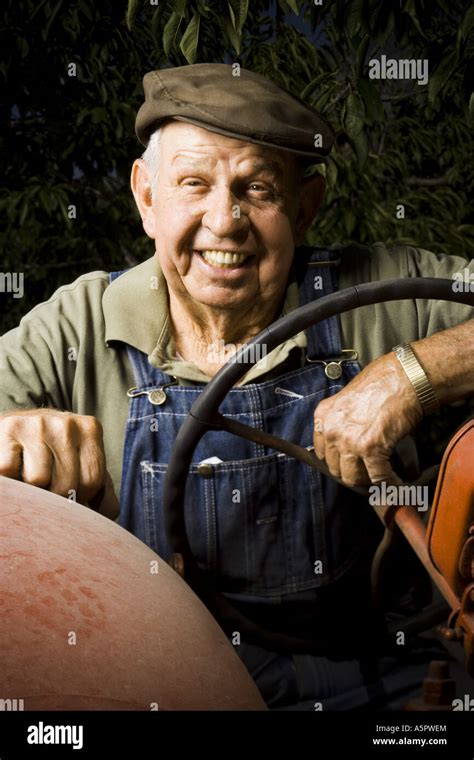 Farmer Posing With His Tractor Stock Photo Alamy