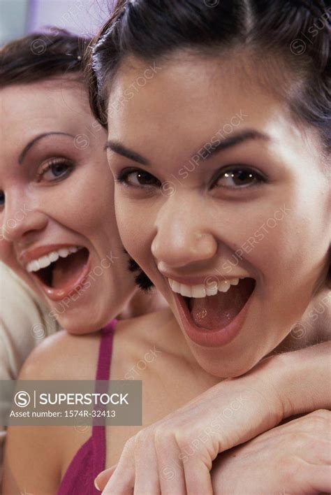 Portrait Of Two Young Women Smiling Superstock