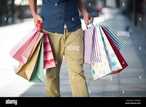 Man Carrying Lots Of Shopping Bags Stock Photo Alamy