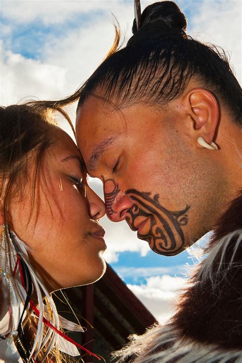 A Maori Man With Ta Moko Facial Tattoo And Woman Doing Hongi