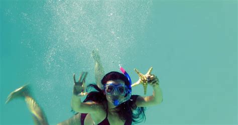 Pretty Brunette Swimming Underwater Into Pool With Snorkel On Her
