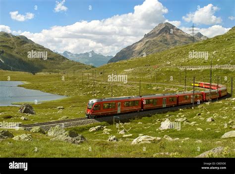 Alpine Train At Lago Bianco At The Bernina Pass In The Swiss Alps Stock