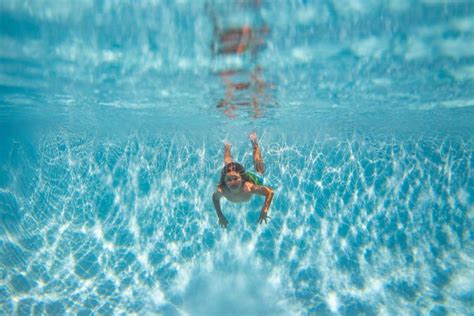 Child Swimming In Pool Underwater Child Boy Swim Under Water In Pool