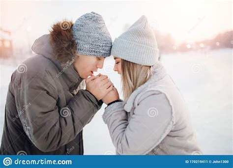 Loving Couple Man And Girl Warm Each Other Hands In Cold In Winter Concept Help And Support