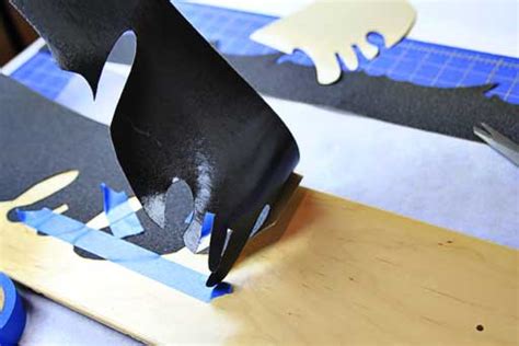 Start out by removing the paper from the skateboard grip tape (so it gets sticky) and then place the sticky side of the griptape facing then, create guidelines for the cut out of the grip tape by scratching the edges of the deck with a tool. How to Make a Custom Skateboard