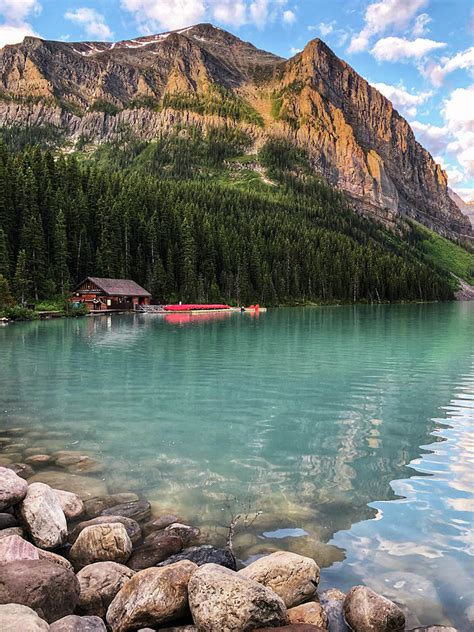 Lake Louise Shoreline With Boathouse And Mountains In The Distance