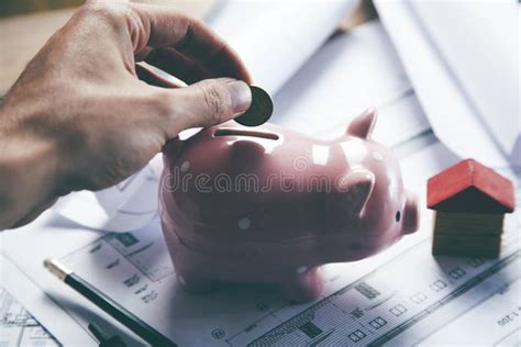 Young Man Depositing Money In Piggy Bank Stock Photo Image Of People
