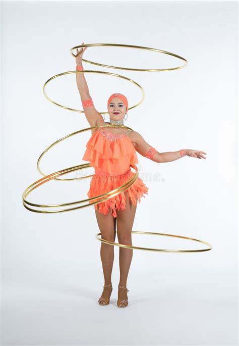 A Charming Girl Performs Circus Elements With A Hula Hoop Stock Photo