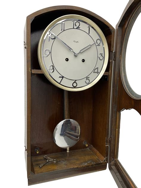 A Mid 20th Century German Wall Clock In A Veneered Mahogany Case With A