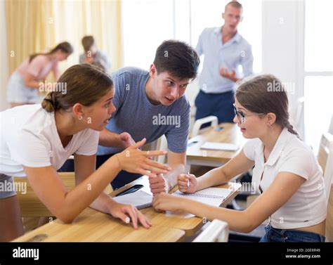 Teenagers Working In Small Groups During Lesson At College Stock Photo