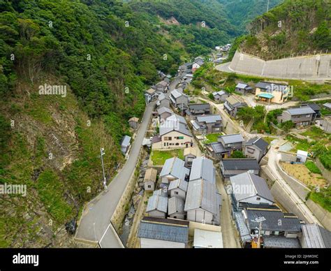 Aerial View Of Small Japanese Village Nestled In Narrow Valley Stock