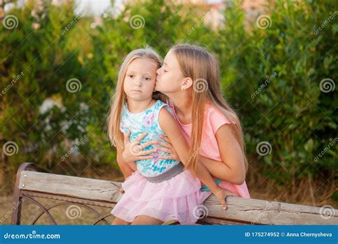 Two Little Girls Sisters Hugging In Park Stock Photo Image Of Happy