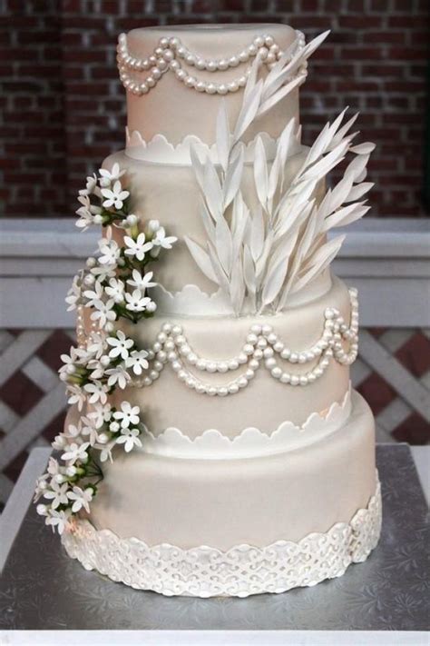 For a romantic and pretty wedding cake on your special day, choose from our collection of decadent recipes and elegant decorating ideas. Four Tier Satin Wedding Cake Decorated In Style #2038675 ...