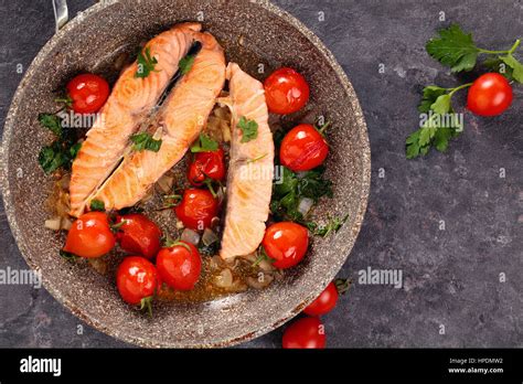 Photo de gros plan Pavé de saumon poêlé au citron et légumes sur poêle